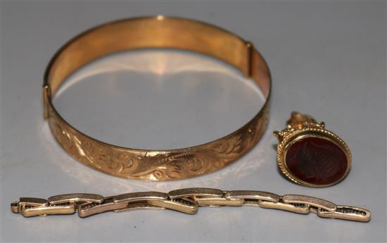 A 9ct gold bangle, part of a 9ct gold watch bracelet and a 9ct gold carnelian set fob seal,